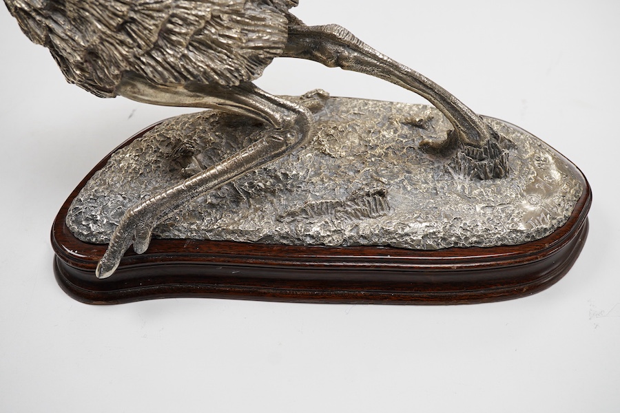 After Tim Nicklin(Kenyan) - A 1980's limited edition silver model of a running ostrich, by Roger John Squires, London, 1986, inscribed 'Tim Nicklin 2/10 1985', on a naturalistic base, fixed to a shaped oval wooden base,